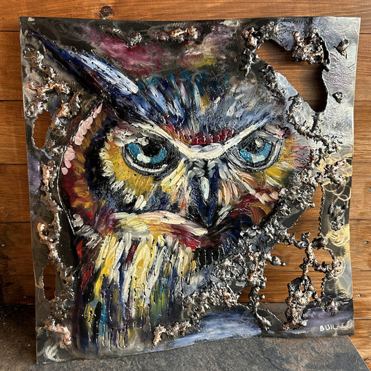 Œuvre murale de Philippe Buil représentant un hibou coloré réalisée en acier, dentelle de bronze et pigments, avec textures métalliques en relief.