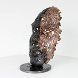 Cette sculpture représente un visage humain, créé avec une technique de dentelle de métal unique.