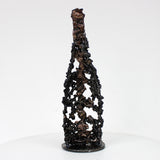 Sculpture de Philippe Buil représentant une bouteille de champagne en dentelle de métal : acier et bronze