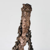 Sculpture de Philippe Buil représentant une bouteille de champagne en dentelle de métal : acier et bronze