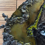 Sculpture murale en acier réalisée par Philippe Buil, représentant un visage de clown inspiré de Bernard Buffet, avec dentelle de métal et pigments colorés.