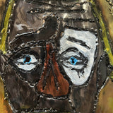 Sculpture murale en acier réalisée par Philippe Buil, représentant un visage de clown inspiré de Bernard Buffet, avec dentelle de métal et pigments colorés.